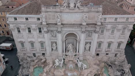tilt down aerial shot of the trevi fountain in rome, italy. famous roman tourist attraction.