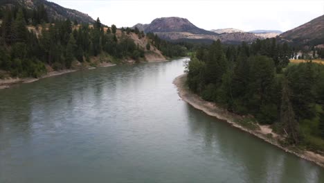 medium aerial shot over the south thompson river by kamloops british columbia in canada on a overcast day in summer