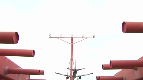 A-jet-airplane-flies-over-a-power-pole-and-prepares-to-land