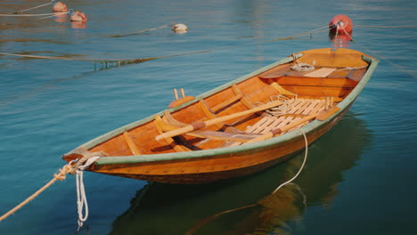 a new wooden boat is moored offshore 4k video