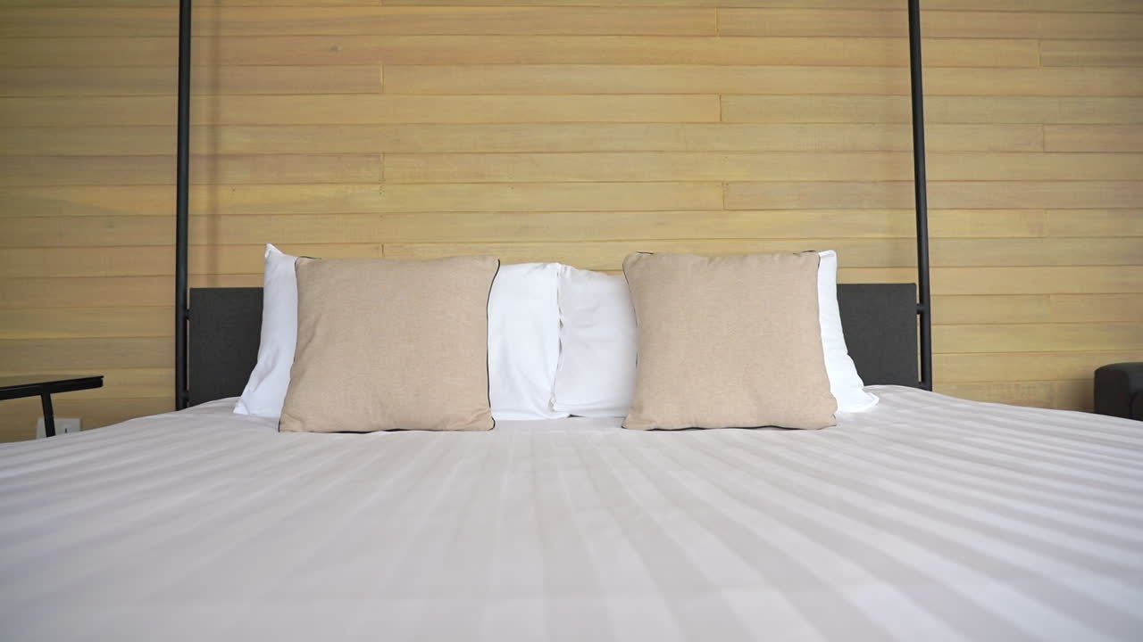 Hotel double room interior in neutral colors, modern and cozy, pan left