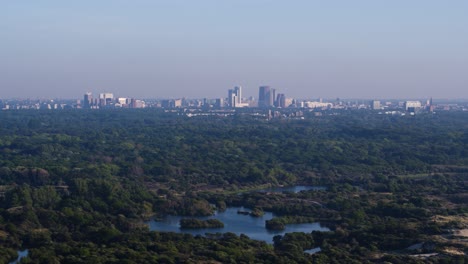 Aerial-truck-left-wide-shot-of-the-Meijendel-Dunes-with-the-city-of-Den-Haag-in-the-background