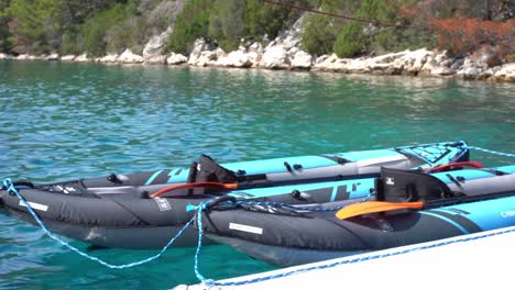 Close-up-shot-of-two-rowboats-tied-to-the-shore-of-Veliko-Jezero-Lake-in-Mljet-National-Park,-Croatia-on-a-sunny-day