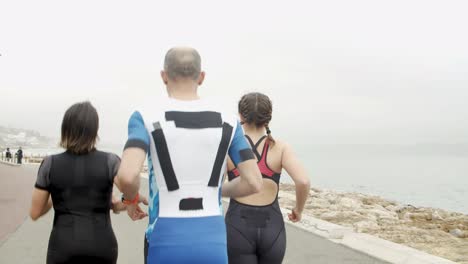 group of athletic friends jogging together