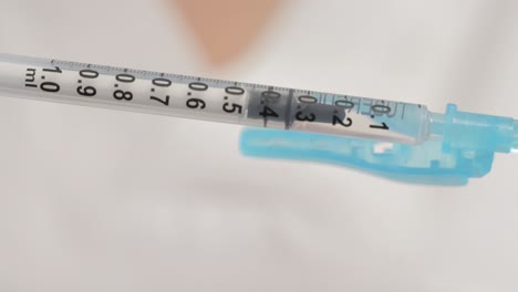 Close-up-of-a-syringe-with-numbers-filling-with-liquid