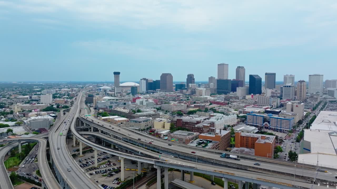Cars Driving Through U.S. Highway 90 Business (US 90 Bus) With New Orleans Skyline In Louisiana, USA. - aerial shot