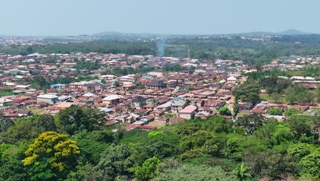 Aerial---Forward-wide-shot-of-a-town-with-rusty-roofs-in-Sub-Saharan-Africa