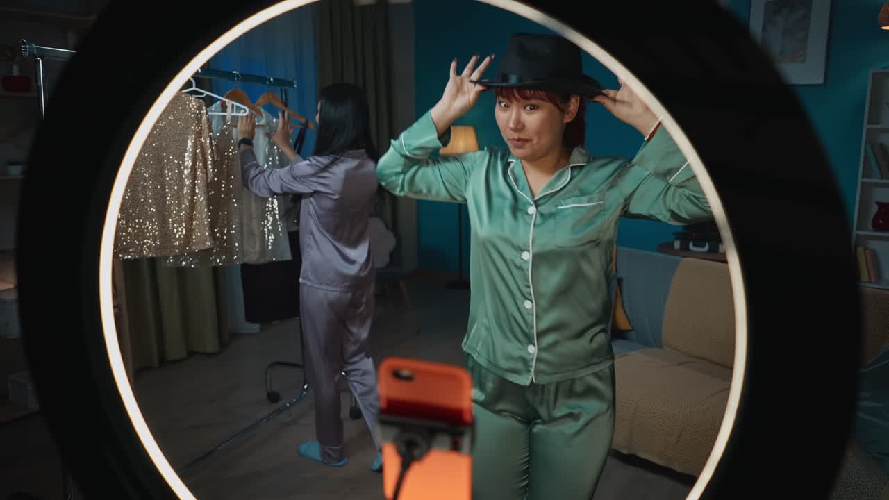 Two Women Dancing in Pajamas for a Social Media Video