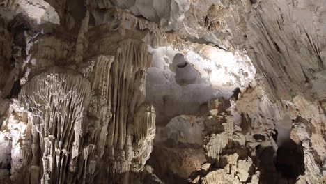 underground cave world with white stalactites and stalagmites