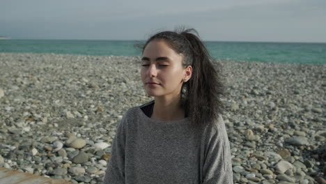 woman meditating on the beach