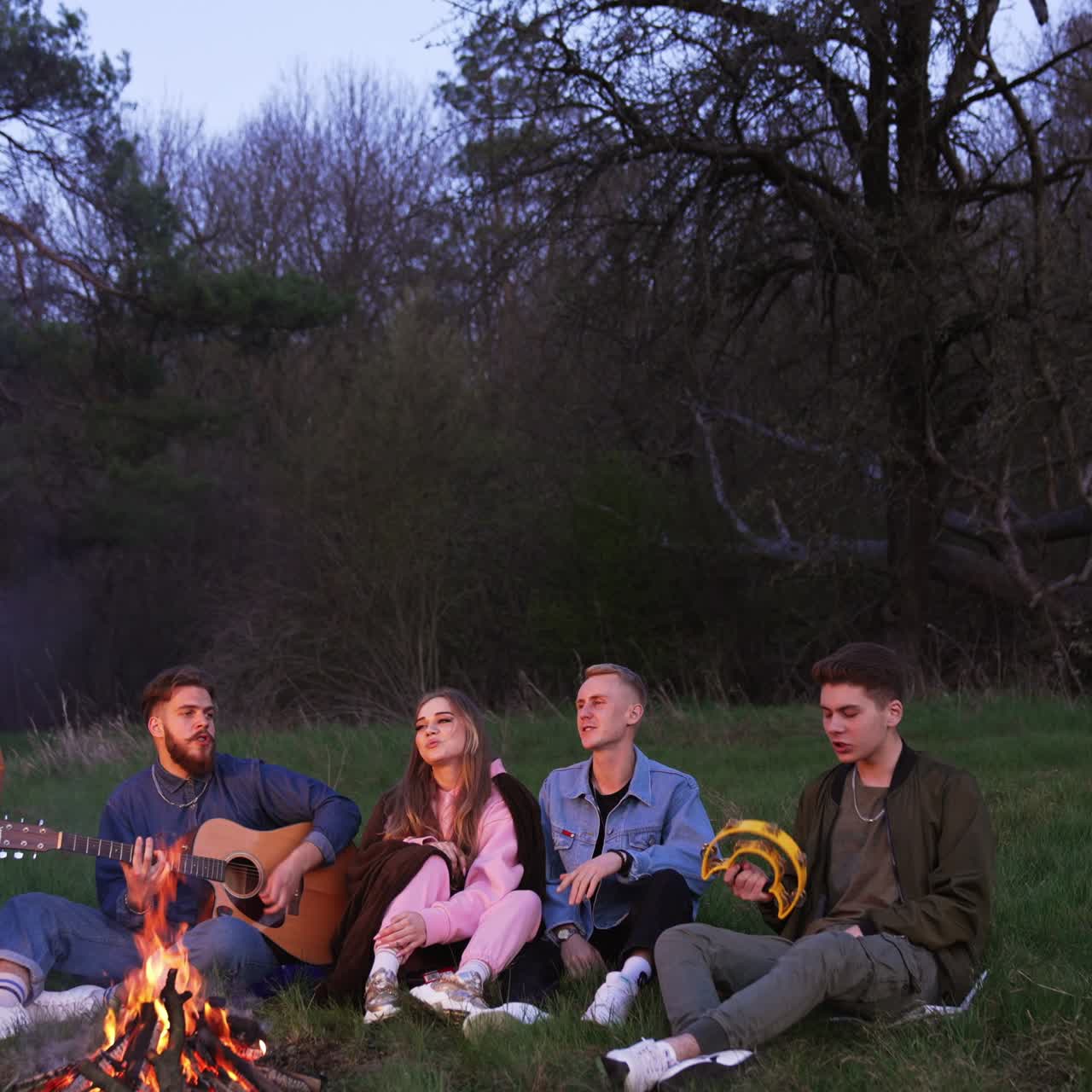 Best friendship people having fun together. Friends sitting near the fire