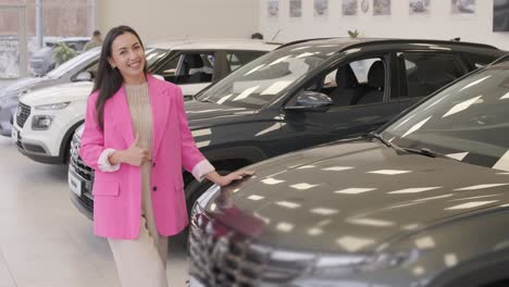 woman choosing a car in a car showroom