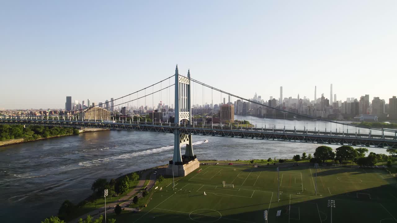 Long dolly drone shot of New York's Randall's Island, Triboro bridge, Manhattan Skyline