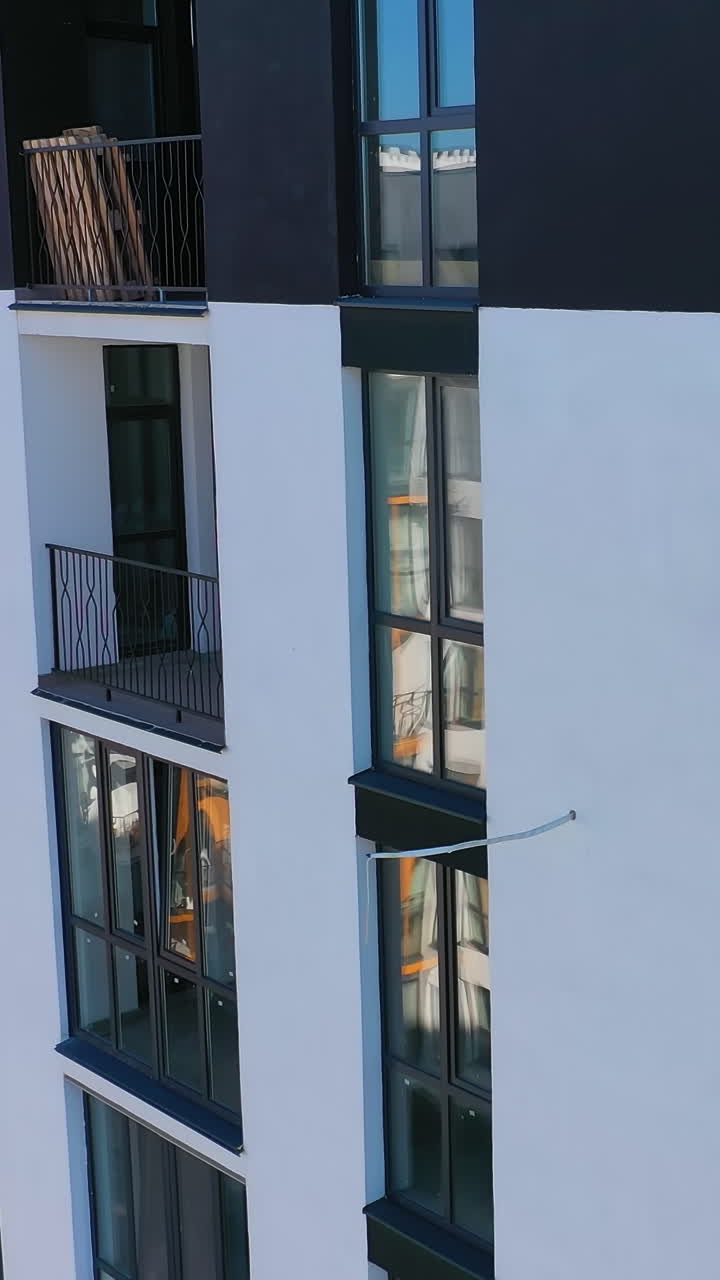 City modern building on aerial view. Contemporary residental building in the city. Vertical video