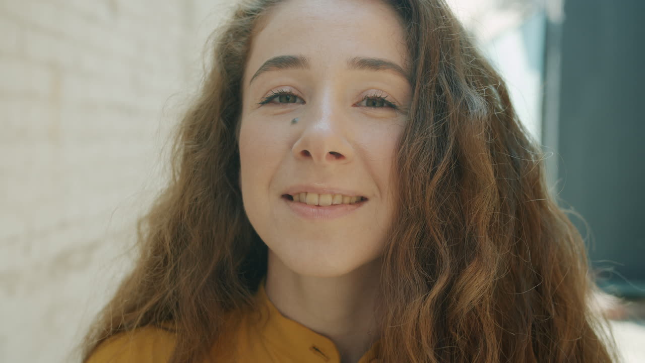 Woman with Curly Hair Smiling Outdoors