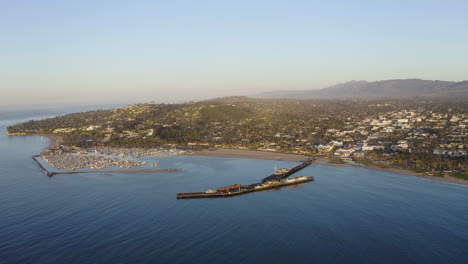 Beautiful-port-town-with-mountains-and-harbor-with-boats-on-ocean-and-pier-4k-prores