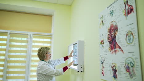 doctor examines x-ray film. doctors with x-ray at office in modern hospital
