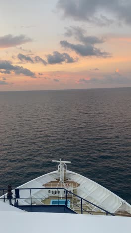 Cruise-Ship-Sailing-On-The-Ocean-At-Sunset