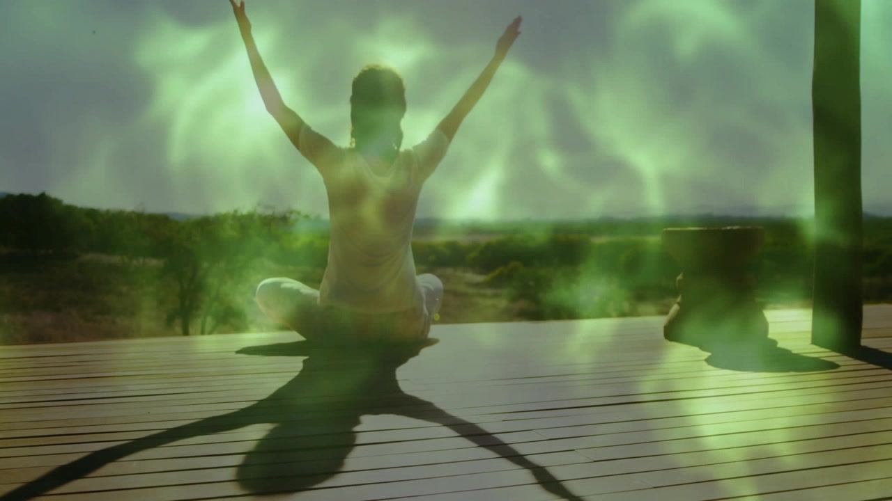 Woman Practicing Yoga on Wooden Deck at Sunrise
