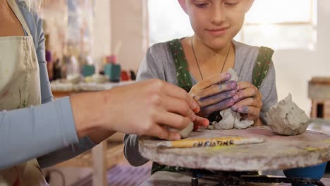 mother and daughter making a toy from clay