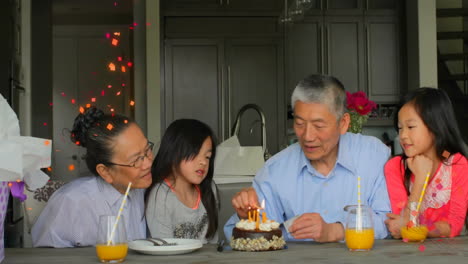 celebrating birthday with cake and candles, family surrounded by confetti animation