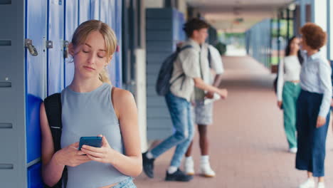 Unhappy-Female-High-School-Or-Secondary-Student-Being-Teased-By-Boys-With-Teacher-Intervening