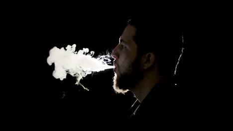 profile silhouette of a man smoking and smoking, black background