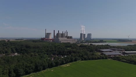 two cooling towers billowing smokes at rwe power ag kraftwerk neurath in germany