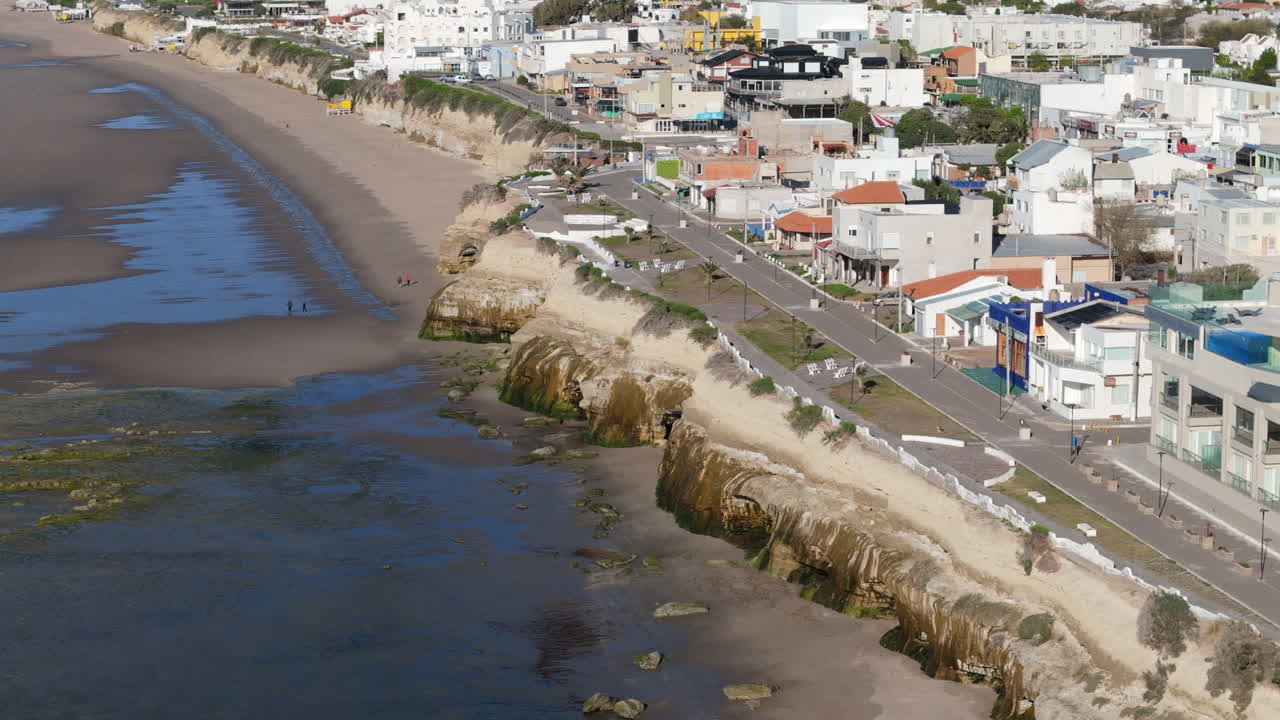 Aerial view of Las Grutas city in Argentina, showcasing the beautiful coastline with its cliffs and sandy beach.