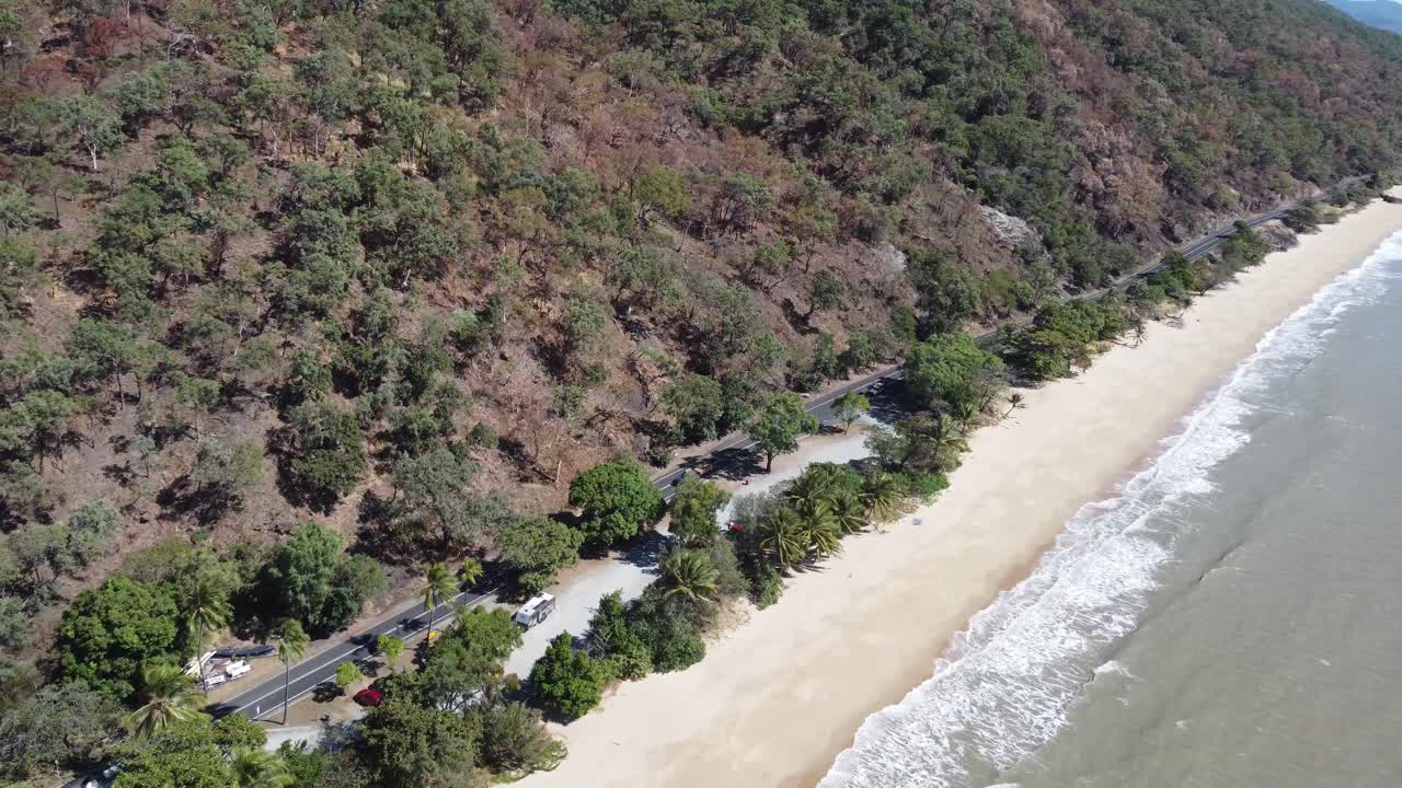 4K Aerial view of a beautiful sandy beach near a highway in Tropical North Queensland, Australia