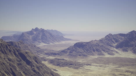 vast desert landscape showcasing rugged mountains and clear sky