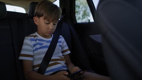 video of boy with mobile phone while riding in car