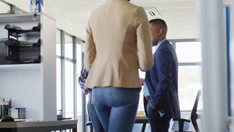 African american business people using laptop at office, slow motion