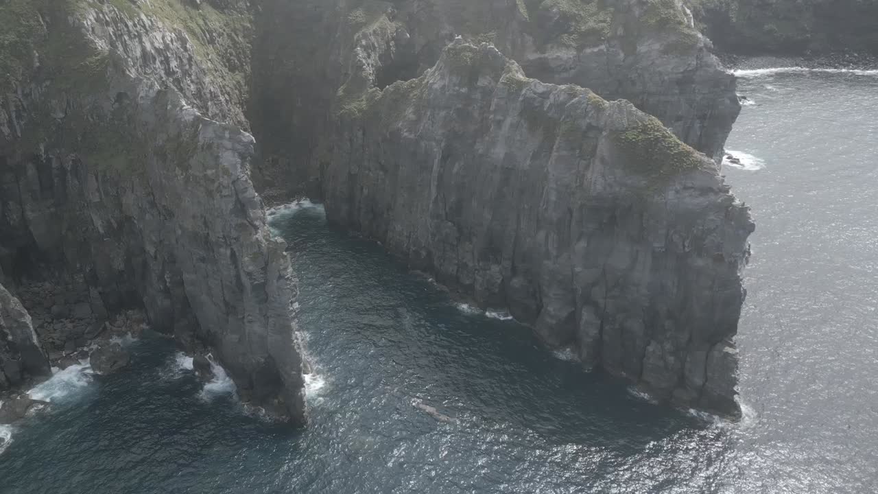 Rocky formations along cliffs of Ponta do Cintrao, Atlantic ocean in Azores archipelago, Portugal