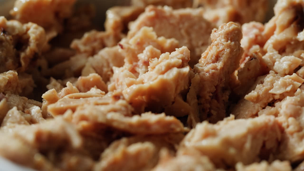 Smoked cod liver in oil in open tin can with fresh greens on wooden table. Seafoods delicacy. High quality 4k footage