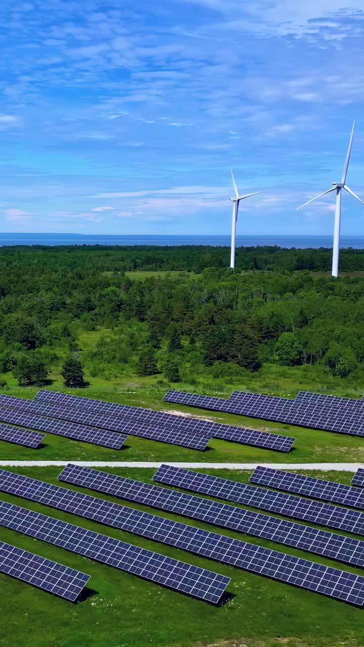Solar panels and wind turbines working together in a clean, sustainable energy field