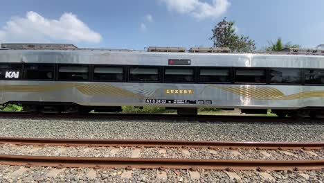 a passenger train is seen passing quickly on the double track.