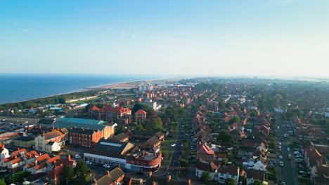 Skegness,-Lincolnshire,-comes-to-life-in-this-aerial-video,-featuring-its-dynamic-tourist-scene,-iconic-pier,-and-expansive-coastline