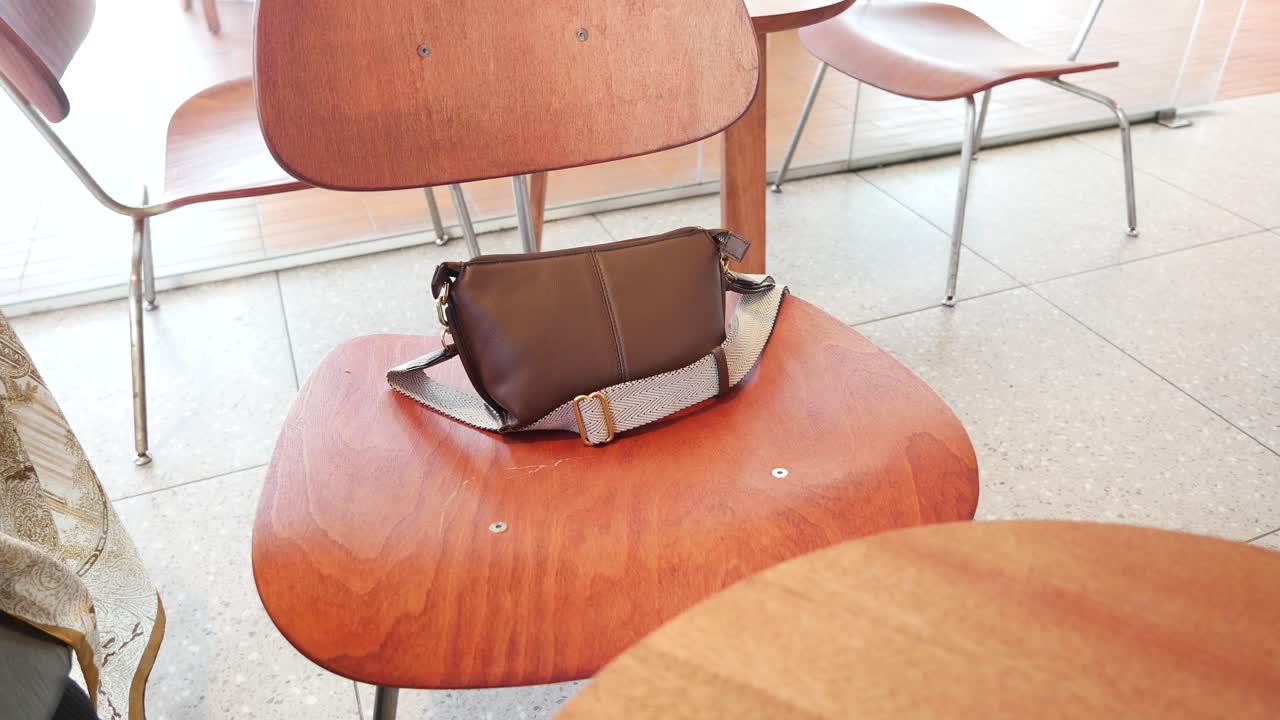 Brown bag on a wooden chair in a cafe