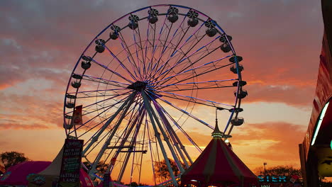 this is 4k footage of a ferris wheel at sunset