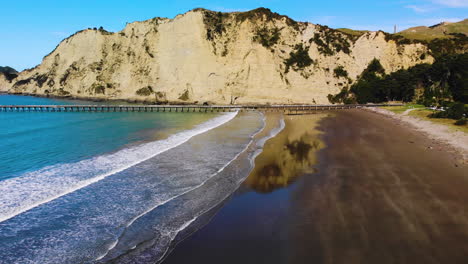 Muelle-De-La-Bahía-De-Tolaga---Panorama-De-La-Playa,-El-Muelle-Y-La-Montaña-En-La-Bahía-De-Tolaga-Cerca-De-Gisborne-En-Nueva-Zelanda