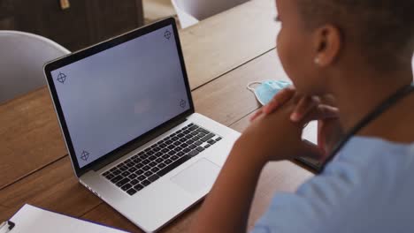 african american female doctor having video call consultation using laptop with copy space