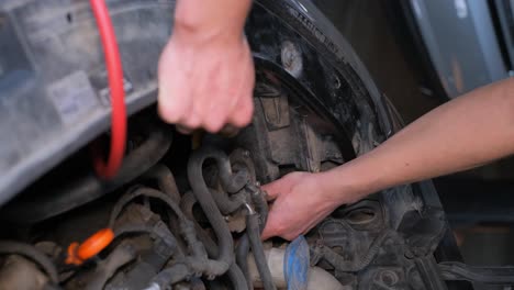 mechanic working on car engine