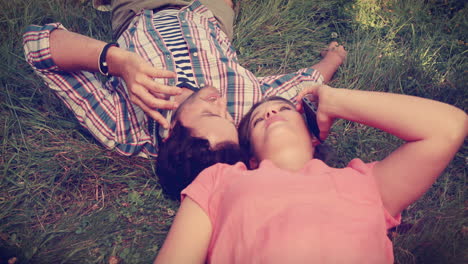 Cute-couple-lying-on-the-grass-and-having-a-phone-call