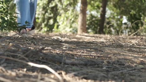 person walking in jeans and platform espadrilles on a natural path