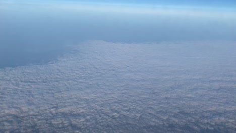 extremely high bird's eye view, skyline, airplane flight, beautiful clouds, view from a porthole