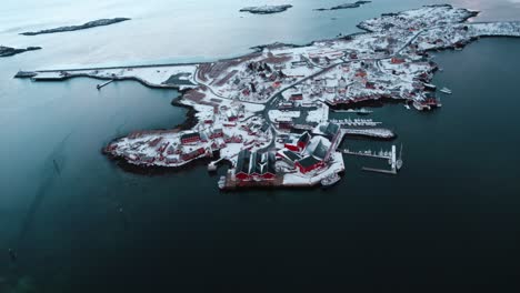 flying drone over reine in the lofoten islands, norway while covered in snow