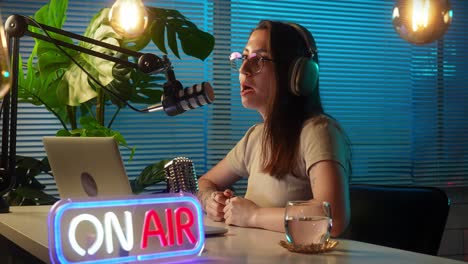woman broadcasting live from a podcast studio