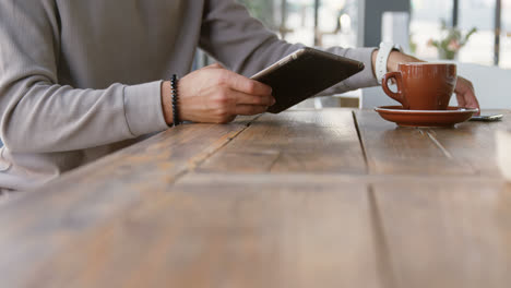 Man-using-digital-tablet-and-mobile-phone-4k