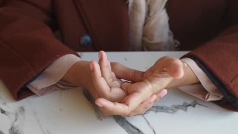 close-up of a woman's hands on a white table